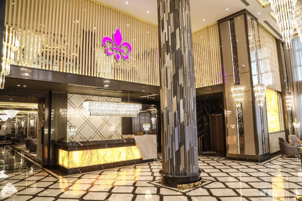 a lobby of a building with a pink butterfly on the ceiling at Iris Hotel Baku - Halal Hotel in Baku