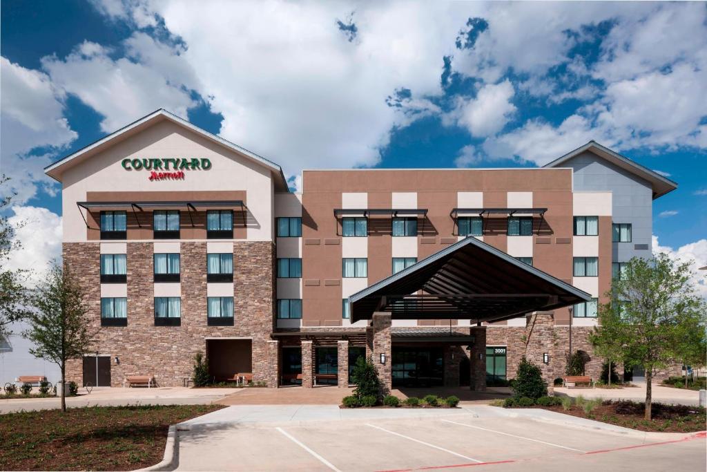 a rendering of the front of a hotel at Courtyard by Marriott Fort Worth Alliance Town Center in Fort Worth