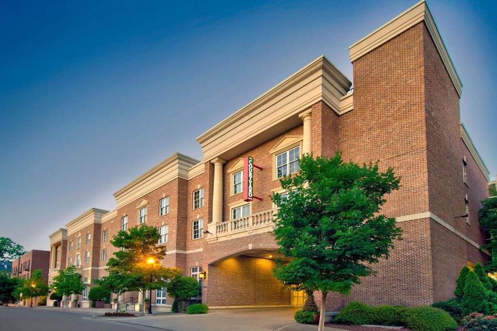 a large brick building with a balcony on a street at Courtyard by Marriott Nashville Green Hills in Nashville