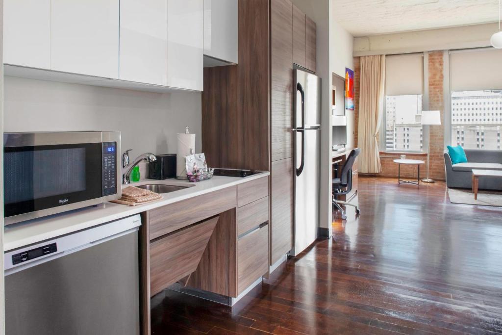 a kitchen with a sink and a refrigerator at TownePlace Suites by Marriott Dallas Downtown in Dallas