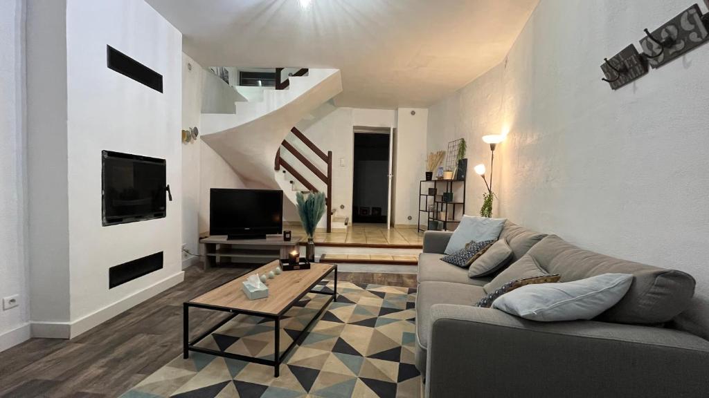 a living room with a couch and a table at Triplex en Cévennes in Saint-Jean-du-Gard