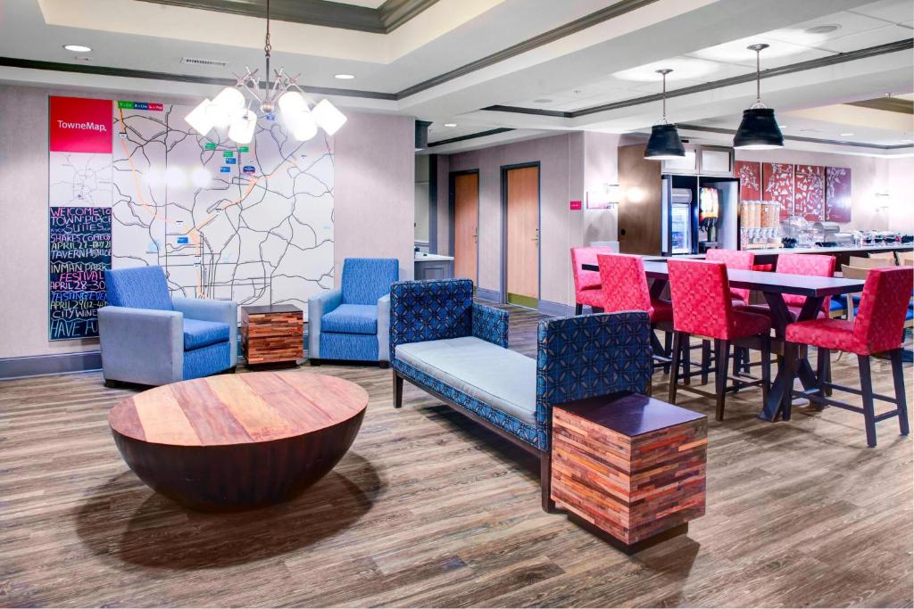 TownePlace Suites Atlanta Buckhead في أتلانتا: غرفة انتظار مع كراسي ملونة وطاولة