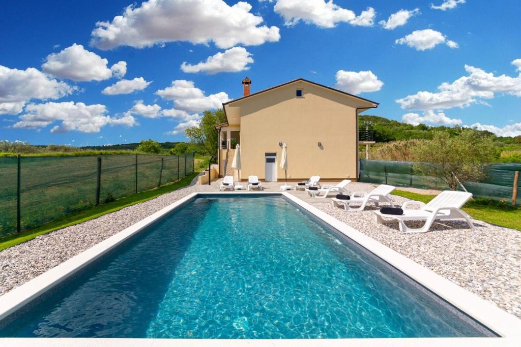 a villa with a swimming pool and a house at Villa Butoniga Nature in Buzet