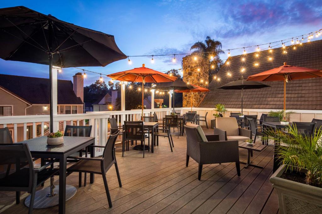 a patio with tables and chairs and umbrellas at Residence Inn San Diego La Jolla in San Diego