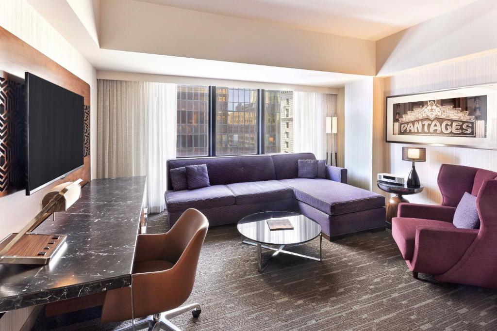a living room with a couch and a table at Sheraton Grand Los Angeles in Los Angeles