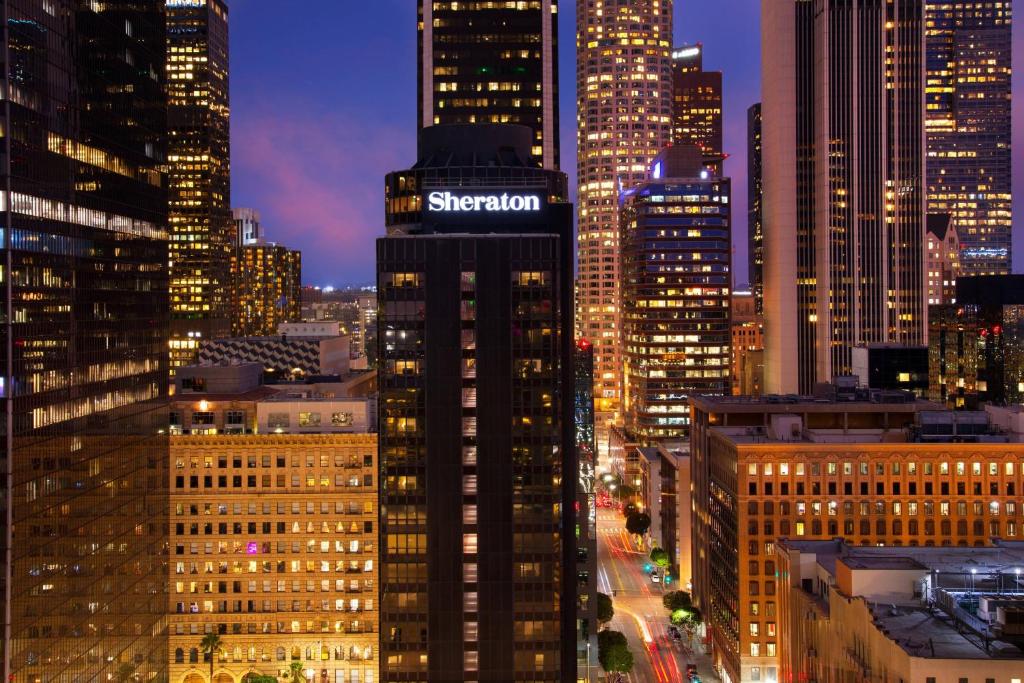 a tall building with a sign on it in a city at Sheraton Grand Los Angeles in Los Angeles