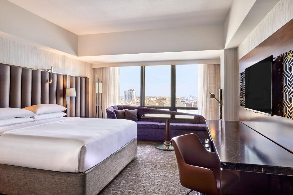 a hotel room with a bed and a couch at Sheraton Grand Los Angeles in Los Angeles