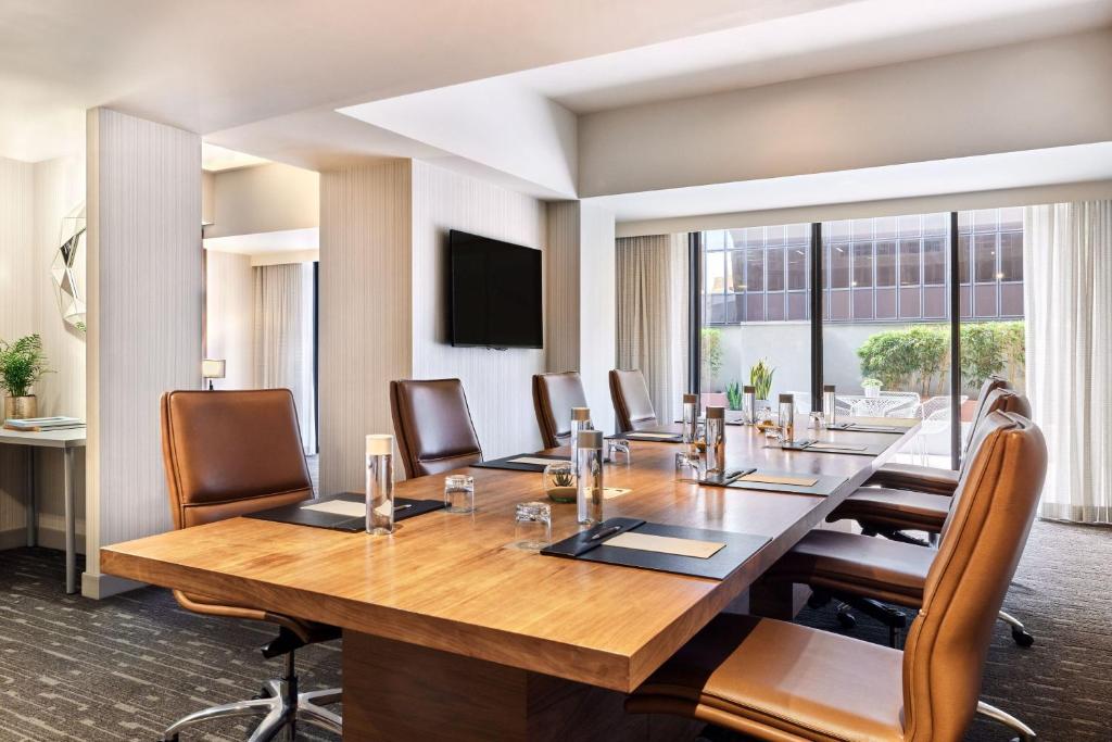 a conference room with a large wooden table and chairs at Sheraton Grand Los Angeles in Los Angeles