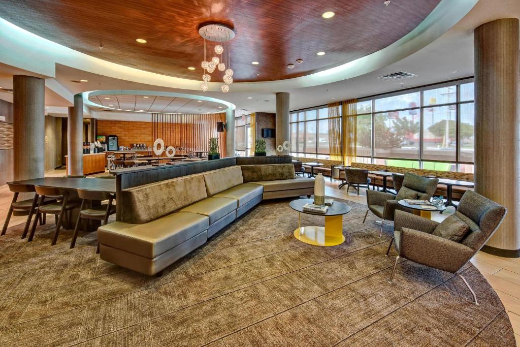 a lobby of a hotel with a couch and a bar at SpringHill Suites by Marriott Oklahoma City Moore in Moore