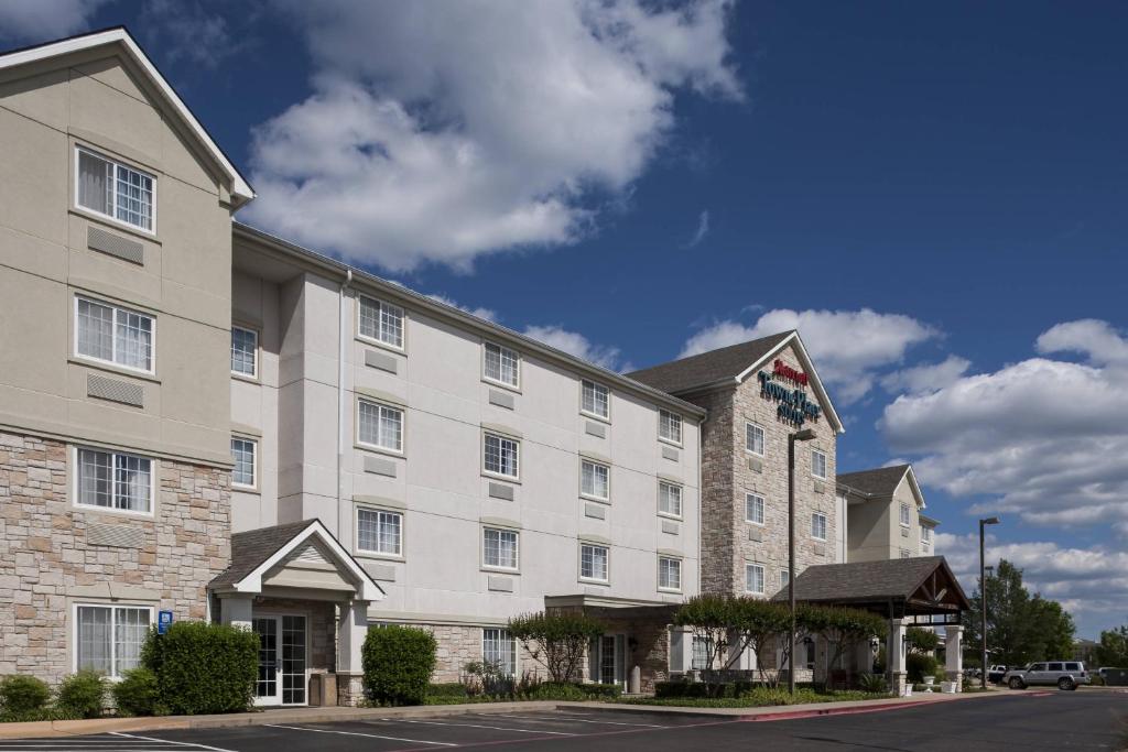 a large white hotel building with a street at TownePlace Suites by Marriott Texarkana in Texarkana