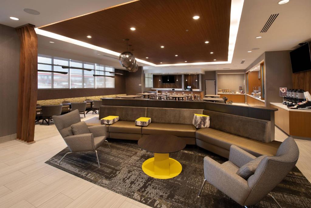 a lobby with a couch and chairs and a bar at SpringHill Suites by Marriott Reno in Reno