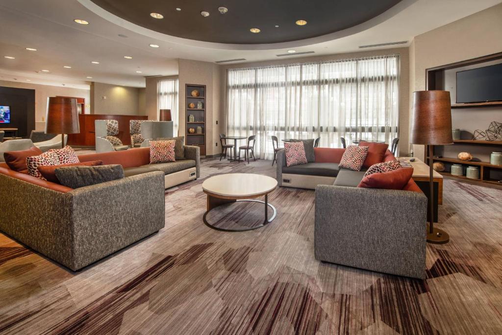 a hotel lobby with couches and a table at Courtyard Dunn Loring Fairfax in Merrifield