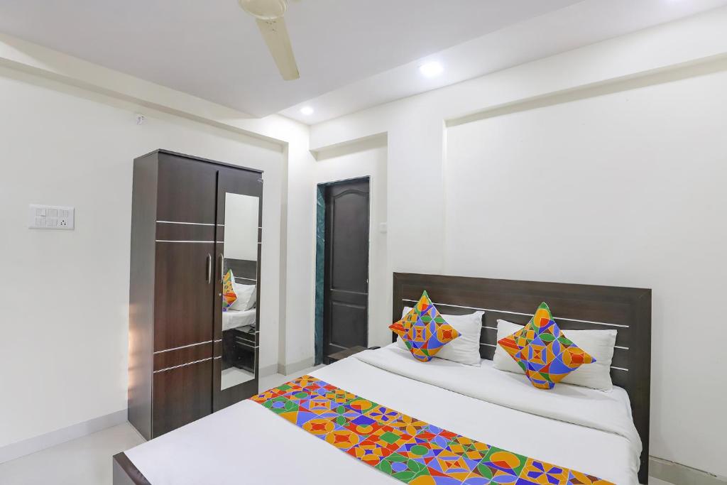 a bedroom with a bed and a mirror at FabHotel Villa 31 in Nagpur