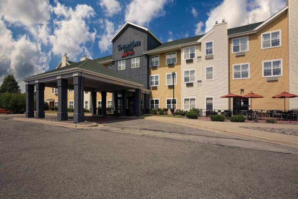 a large hotel with a building and a street at TownePlace Suites Rochester in Rochester