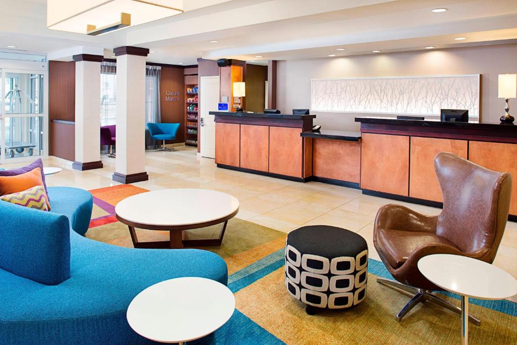 a lobby with tables and chairs and a waiting room at Fairfield Inn & Suites by Marriott Jonesboro in Jonesboro