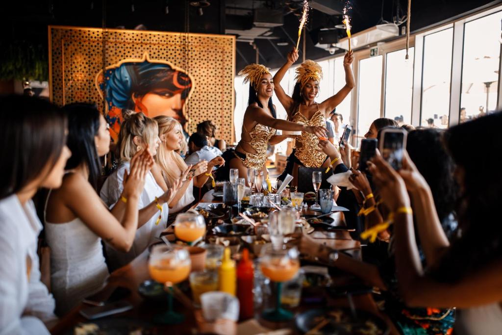 a group of people sitting around a table at a party at FIVE Jumeirah Village in Dubai