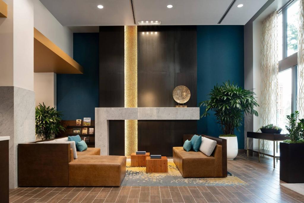 a lobby with two couches and a fireplace at Courtyard Seattle Downtown / Pioneer Square in Seattle