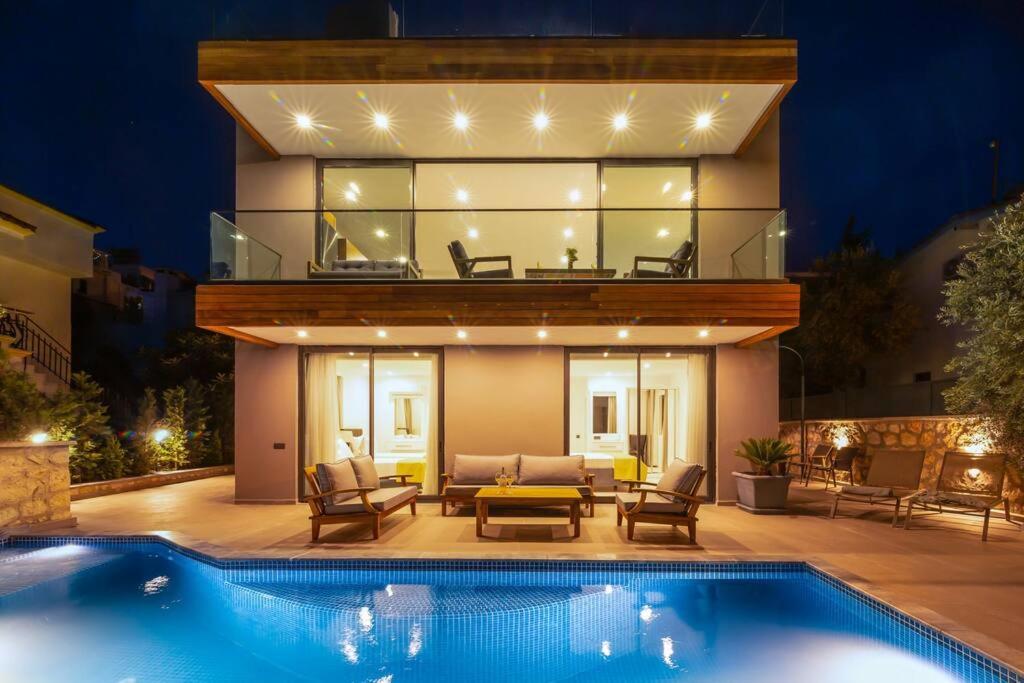 a house with a swimming pool in front of a house at Gorgeous 3 Bedroom Property at Kalamar Bay in Kalkan