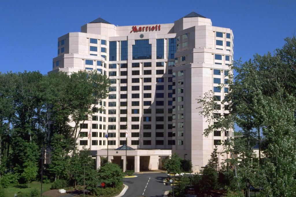 a building with an atrium sign on top of it at Falls Church Marriott Fairview Park in Falls Church