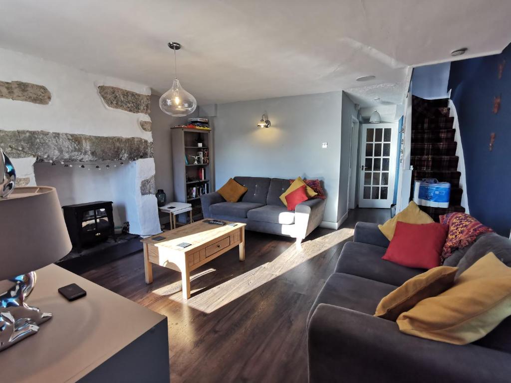 a living room with a couch and a table at No 8 Snowdonia. 3 Bedroom, sleeps 5. Pets accepted in Blaenau-Ffestiniog