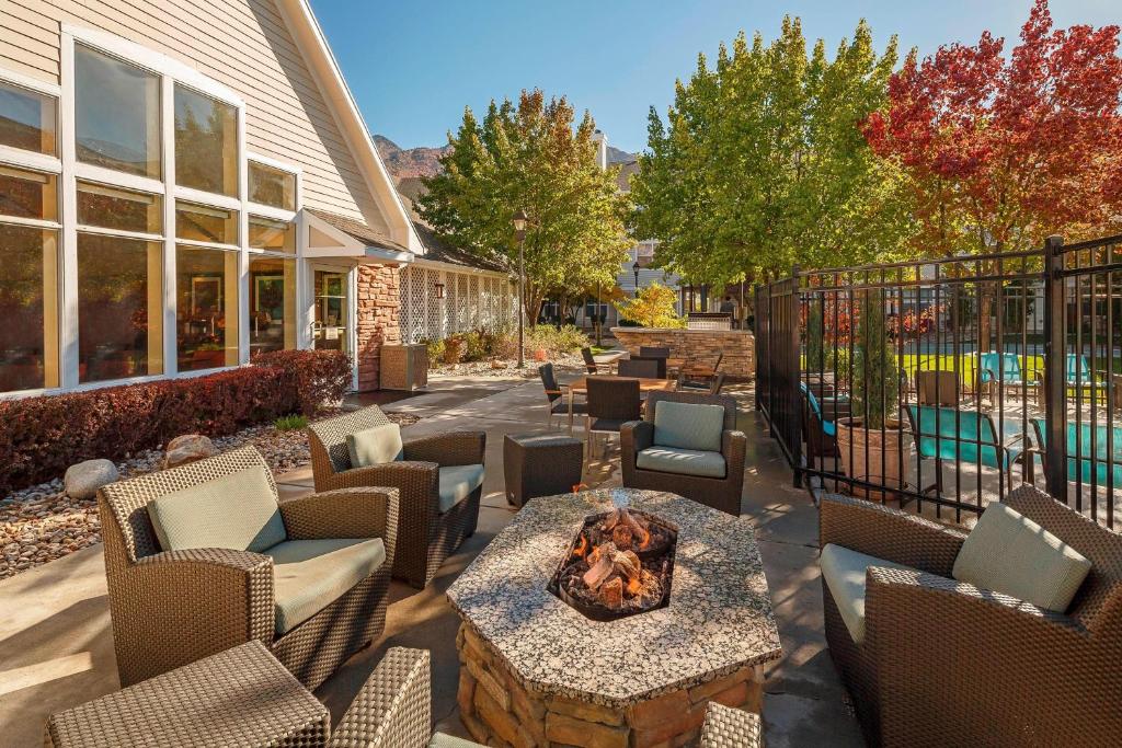 a patio with chairs and a fire pit in a yard at Residence Inn Salt Lake City Cottonwood in Cottonwood Heights