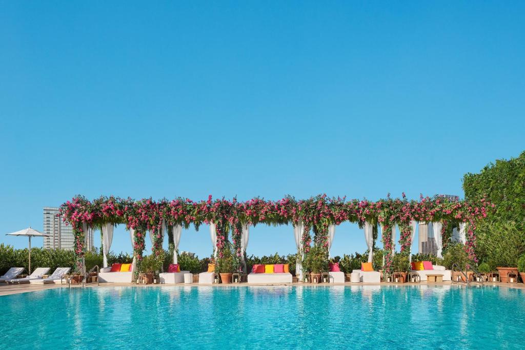a pool at a resort with a floral pergola at The Tampa EDITION in Tampa