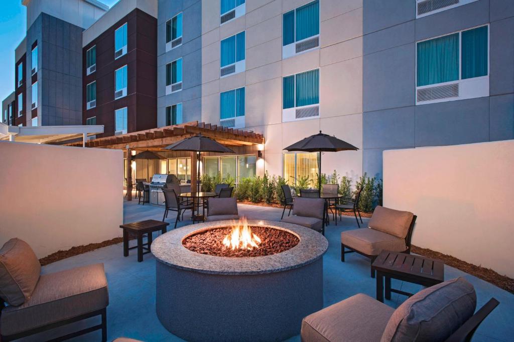 a patio with a fire pit in front of a building at TownePlace Suites by Marriott Lakeland in Lakeland