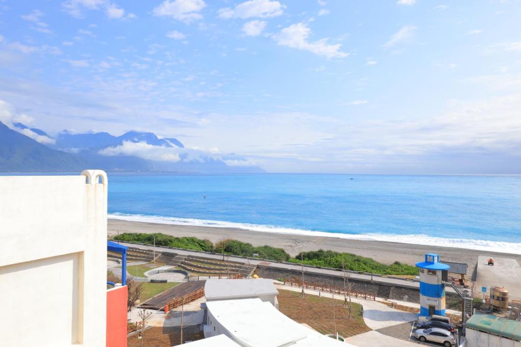 a view of the beach from the balcony of a building at Go to Qixingtan Seaview B&B in Dahan