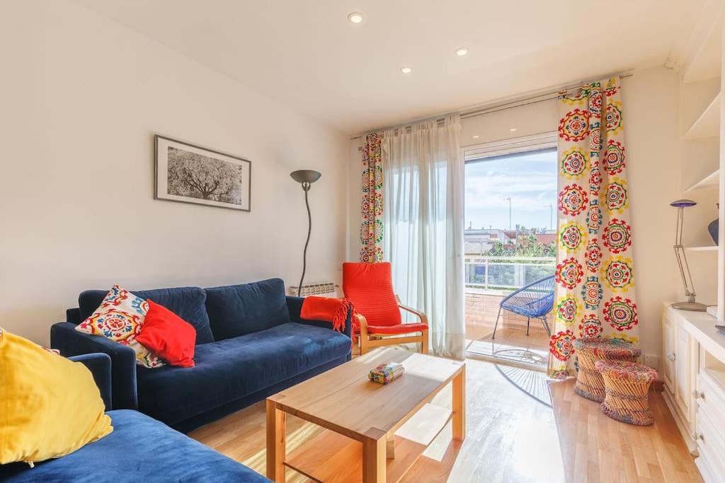 een woonkamer met een blauwe bank en een tafel bij Excelente ubicación en Vilafranca del Penedes in Vilafranca del Penedès