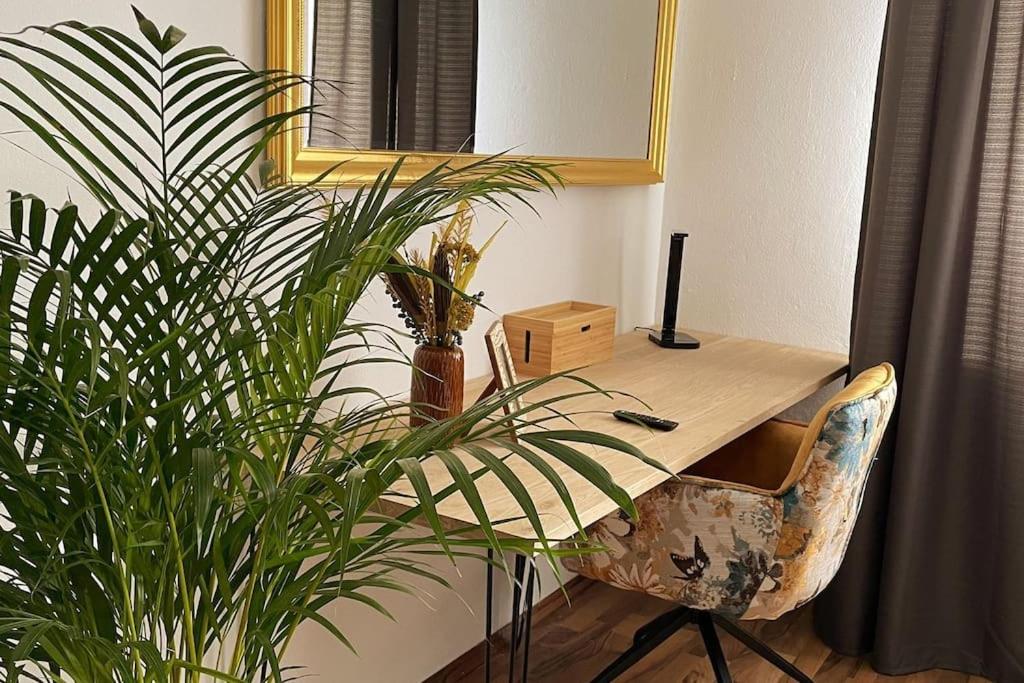 a desk in an office with a potted plant at SANO - bei Joseph in Hagen- modernes Ambiente - Home office - Highspeed Internet - Waschmaschine in Hagen