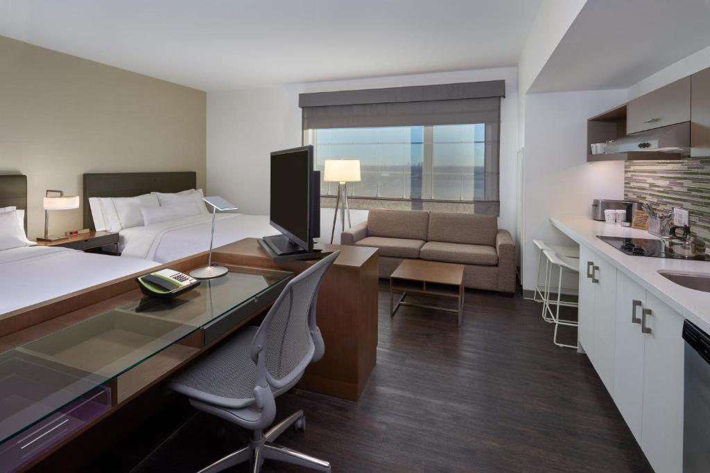 a hotel room with a bed and a desk and a kitchen at Element Vaughan Southwest in Vaughan