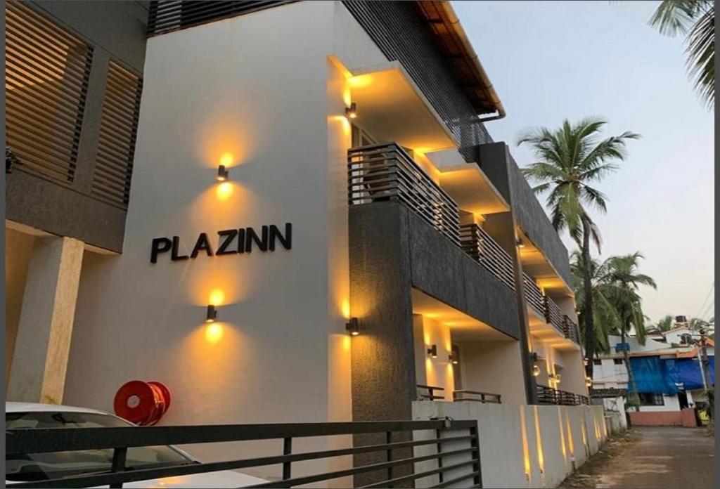a building with lights on the side of it at The Plazinn by Legends Hotels in Candolim