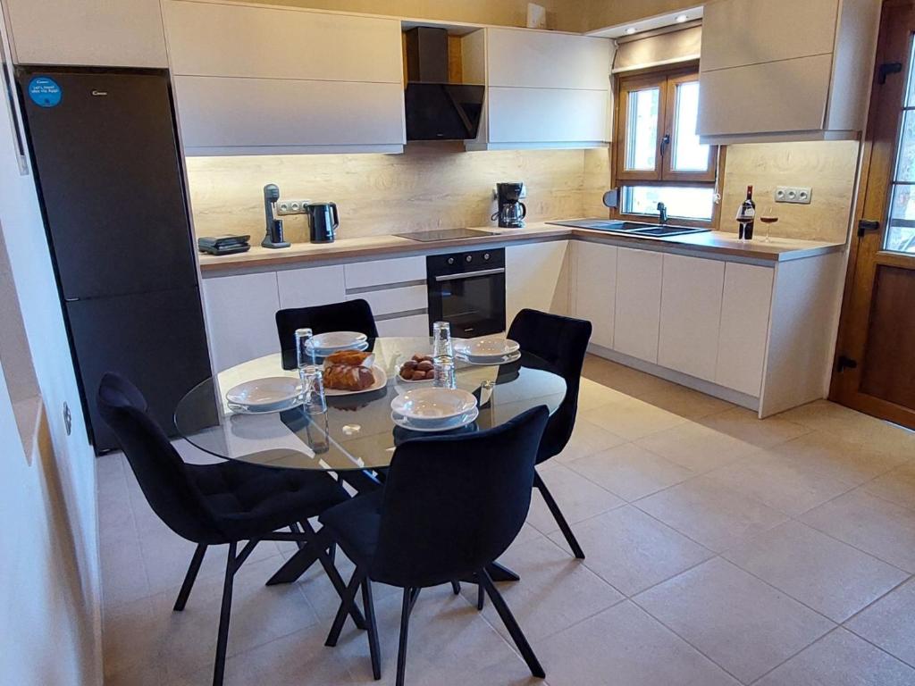 a kitchen with a table and chairs in a kitchen at Villa Natural View in Moutsoúna