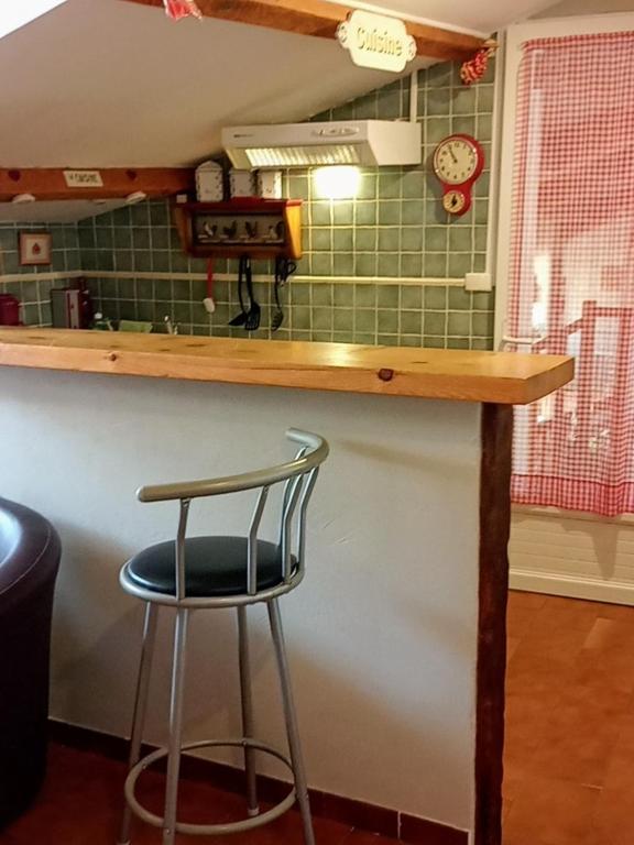 a stool sitting at a counter in a kitchen at Gîte Chez Dado &amp; Denis Saint Martin d&#39;Ardèche in Saint-Martin-dʼArdèche