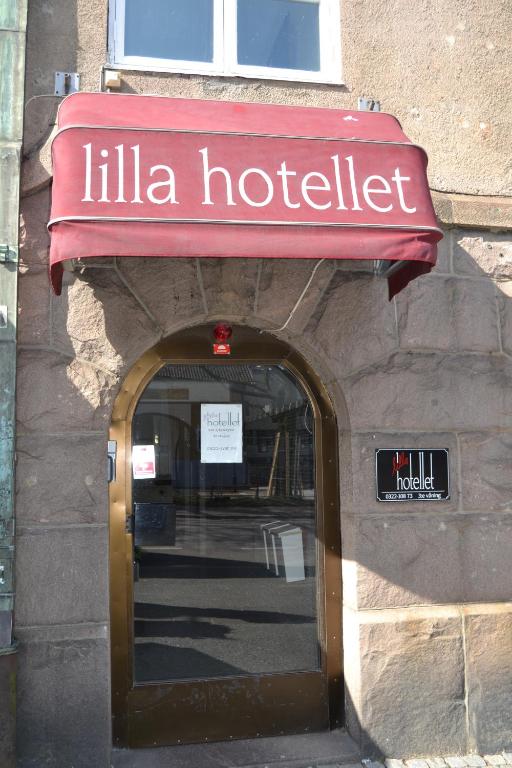 an entrance to a hotel with a red sign on a building at Lilla Hotellet Bed & Breakfast i Alingsås in Alingsås