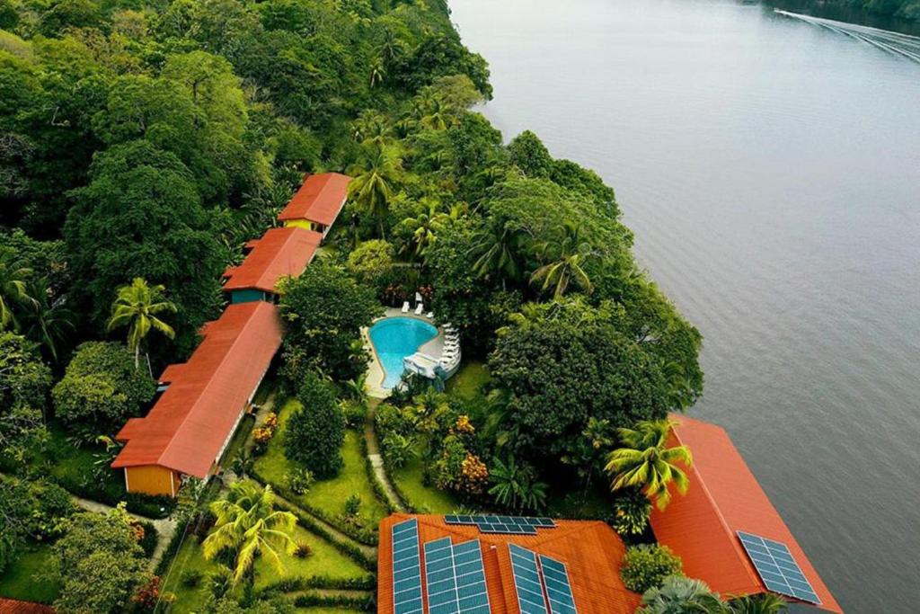 an aerial view of a house on an island in the water at La Baula Lodge in Tortuguero