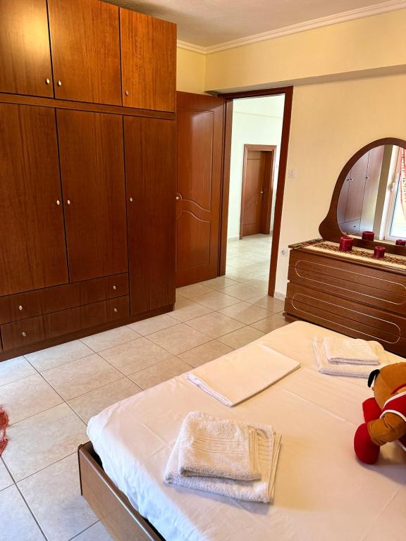 A bed or beds in a room at Archontia Apartment