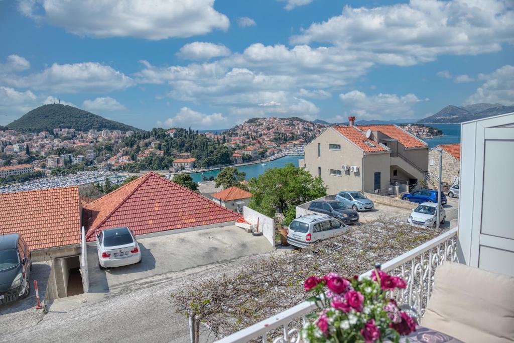 a view from the balcony of a house with cars parked at Guesthouse Victoria II in Dubrovnik