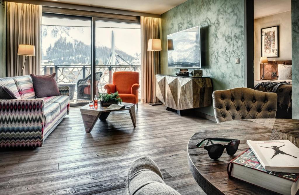 a living room with a view of a mountain at Valsana Ferienwohnungen Arosa in Arosa
