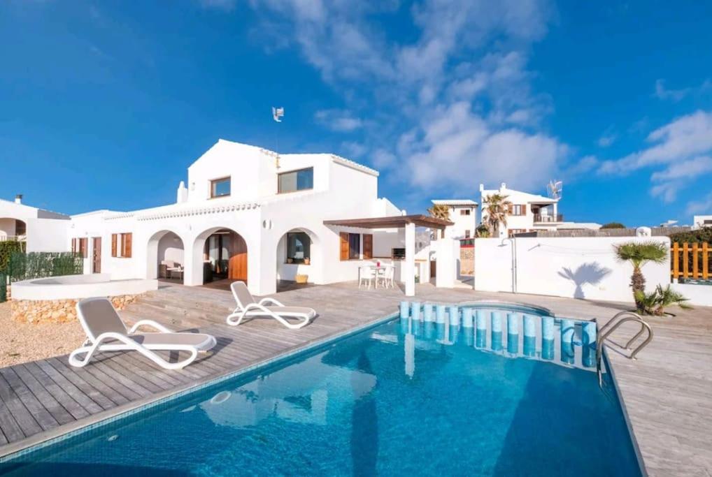 a villa with a swimming pool and a house at Villa Amor in Cala Morell