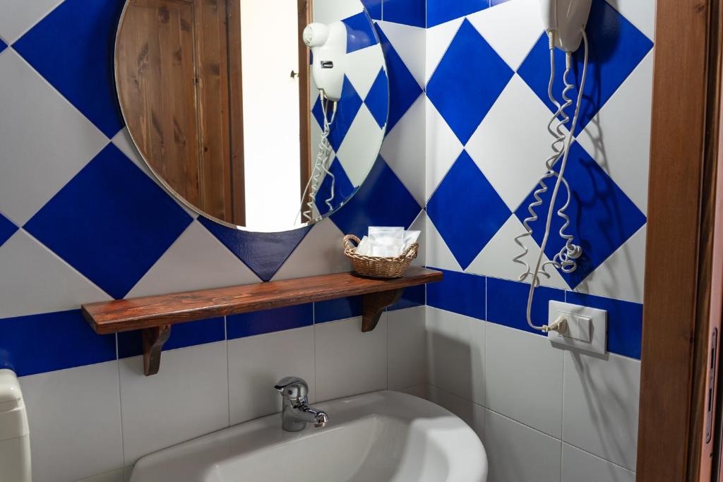 a bathroom with a mirror and a sink at Casale Ginisara in Castellammare del Golfo