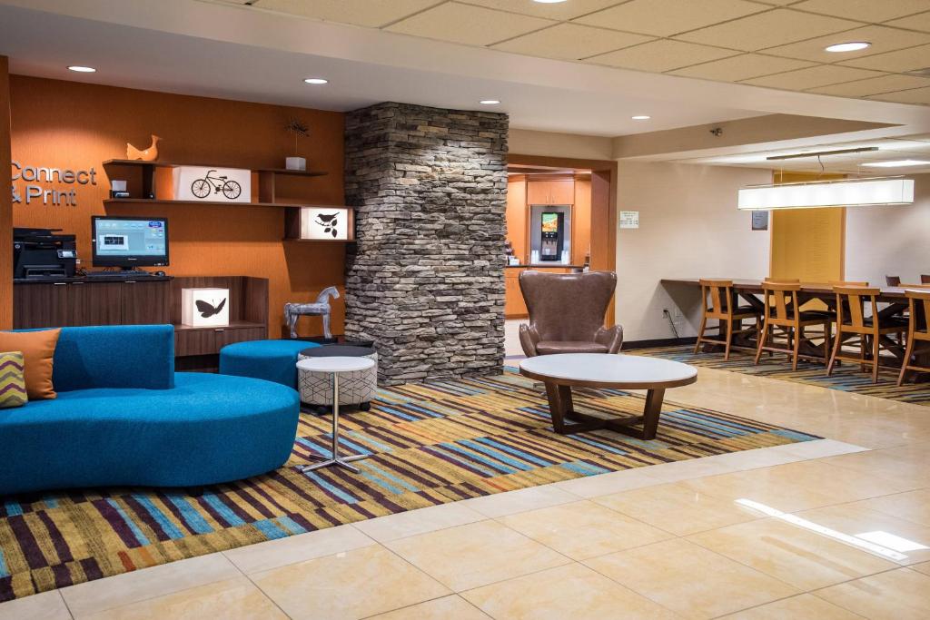 a lobby with a blue couch and chairs and a table at Fairfield Inn & Suites by Marriott Knoxville/East in Knoxville