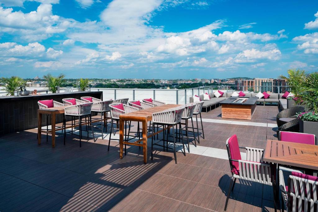 a patio with tables and chairs on a roof at Courtyard by Marriott Washington Downtown/Convention Center in Washington, D.C.