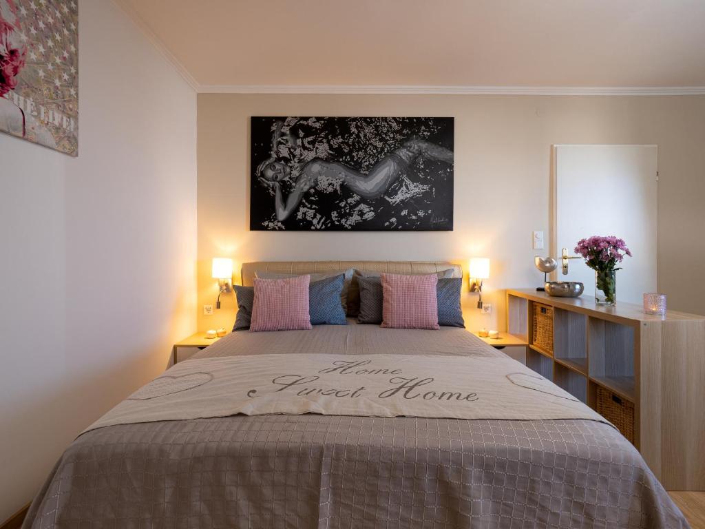 - une chambre avec un grand lit et des oreillers roses dans l'établissement Ferienwohnung im Herzen vom Sylt, à Westerland