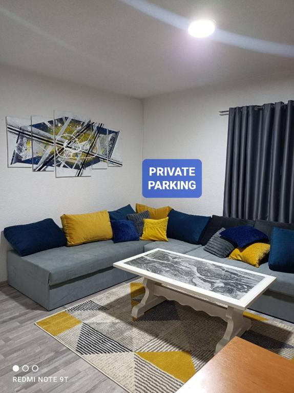 a living room with a couch and a table at Kavkaz Apartment in Sarajevo