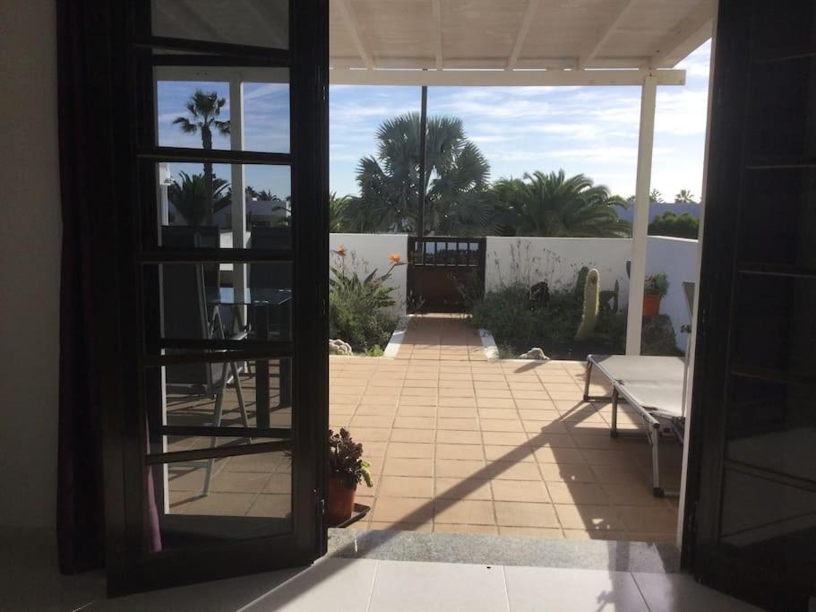 a door to a patio with a view of a courtyard at Natural y sano: Charco del Palo in Charco del Palo