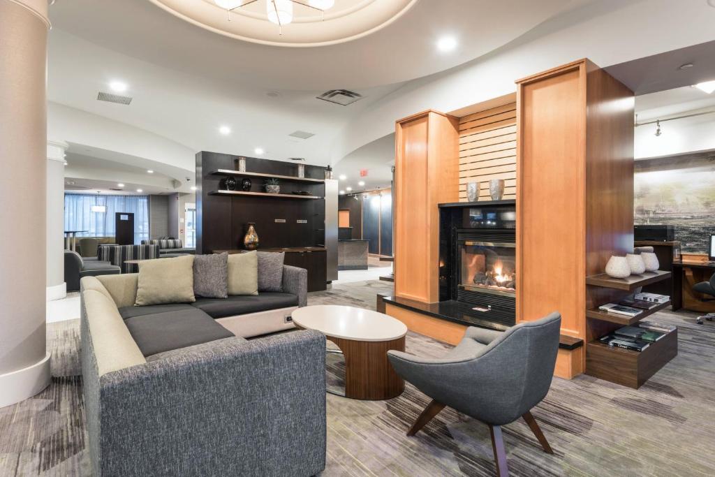 a living room with a couch and a fireplace at Courtyard by Marriott Toronto Vaughan in Vaughan