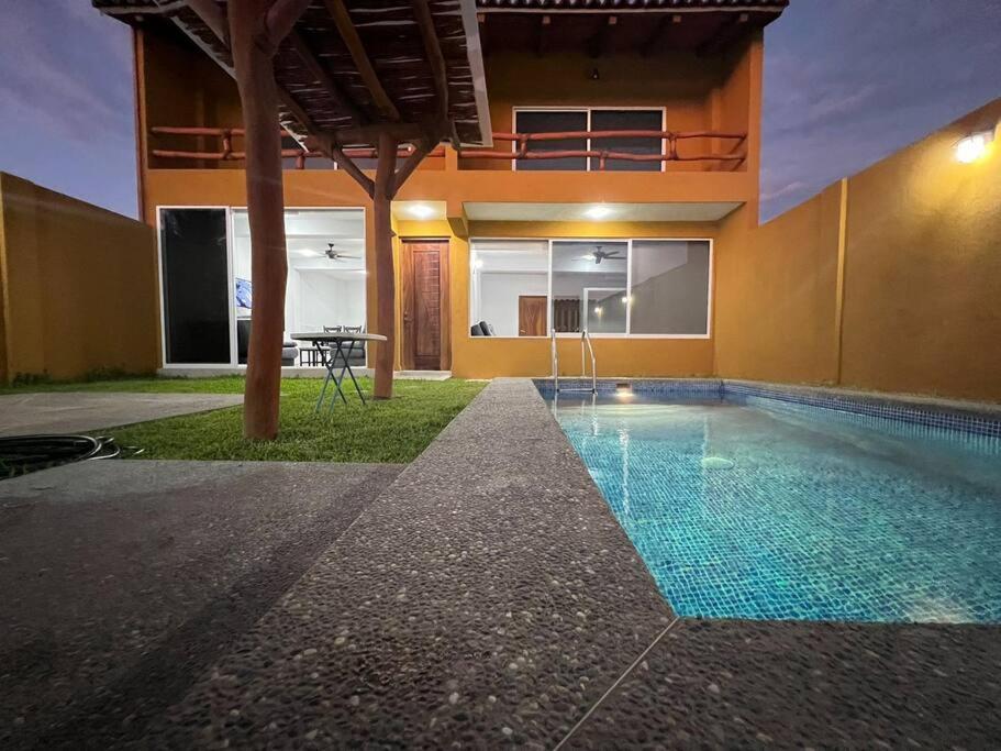 a swimming pool in the middle of a building at Casa Hipocampo in El Coacoyul