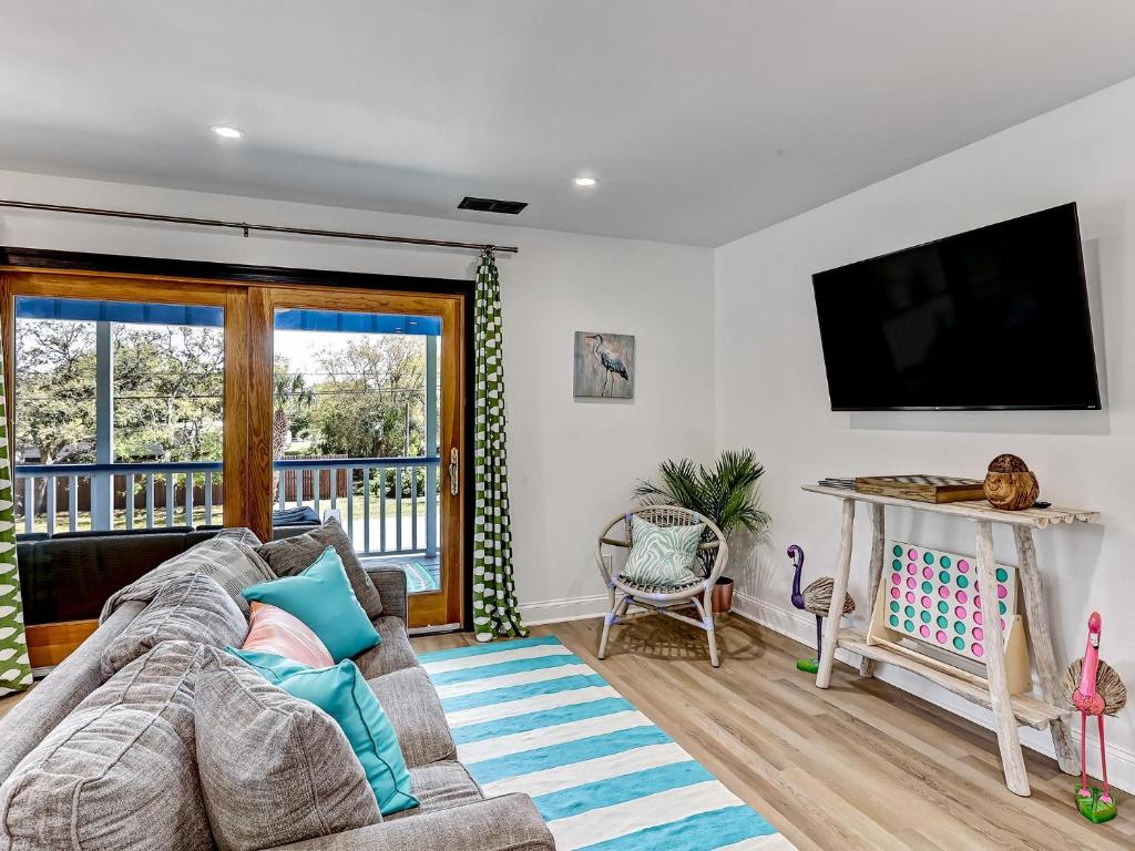 ein Wohnzimmer mit einem Sofa und einem Flachbild-TV in der Unterkunft Deja Blue A in Tybee Island