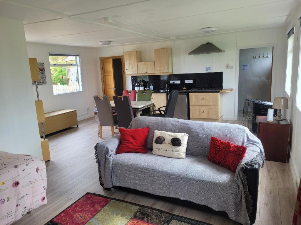 a living room with a couch with pillows on it at The Cabin Getaway in Derry Londonderry